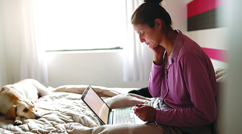 Woman read laptop on bed