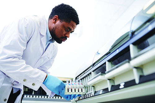 An African American male working with lab equpiment