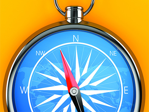 A blue compass in front of a yellow background