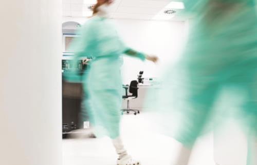 Lab professionals rush in a hospital because they are understaffed.
