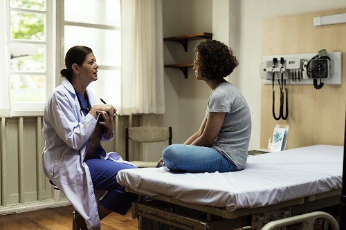 A woman speaks with a healthcare provider about her test results