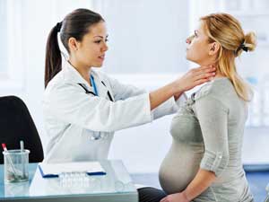 Doctor giving pregnant woman a check up